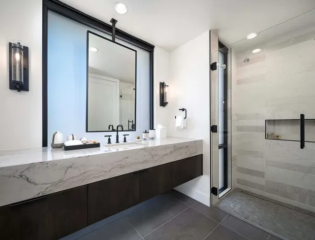 Bathroom with a stone vanity and a walk-in rain shower