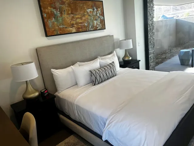 Second bedroom with an upholstered headboard and desert art
