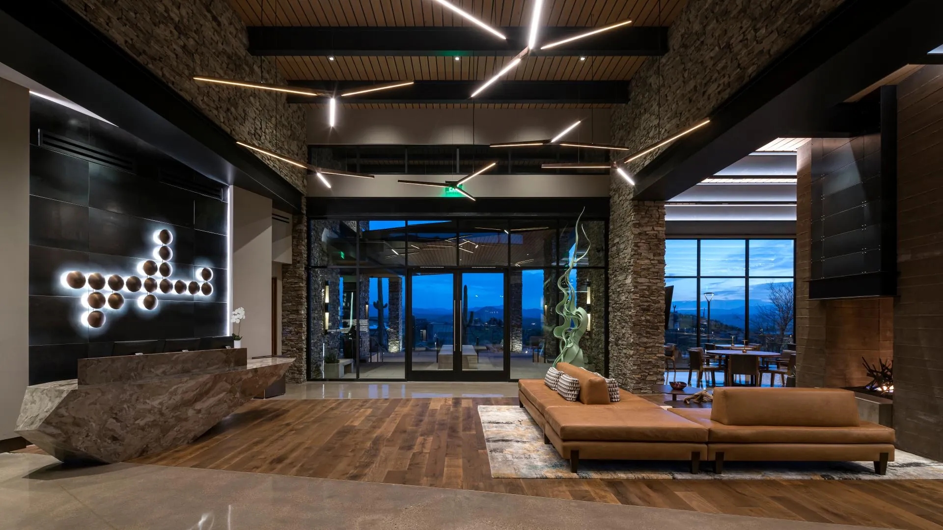 The Lodge lobby lounge with a stone fireplace and leather sofa