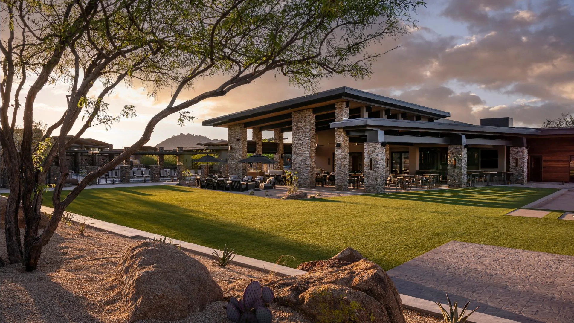 The Lodge and its lawn at sunset, framed by a palo verde tree