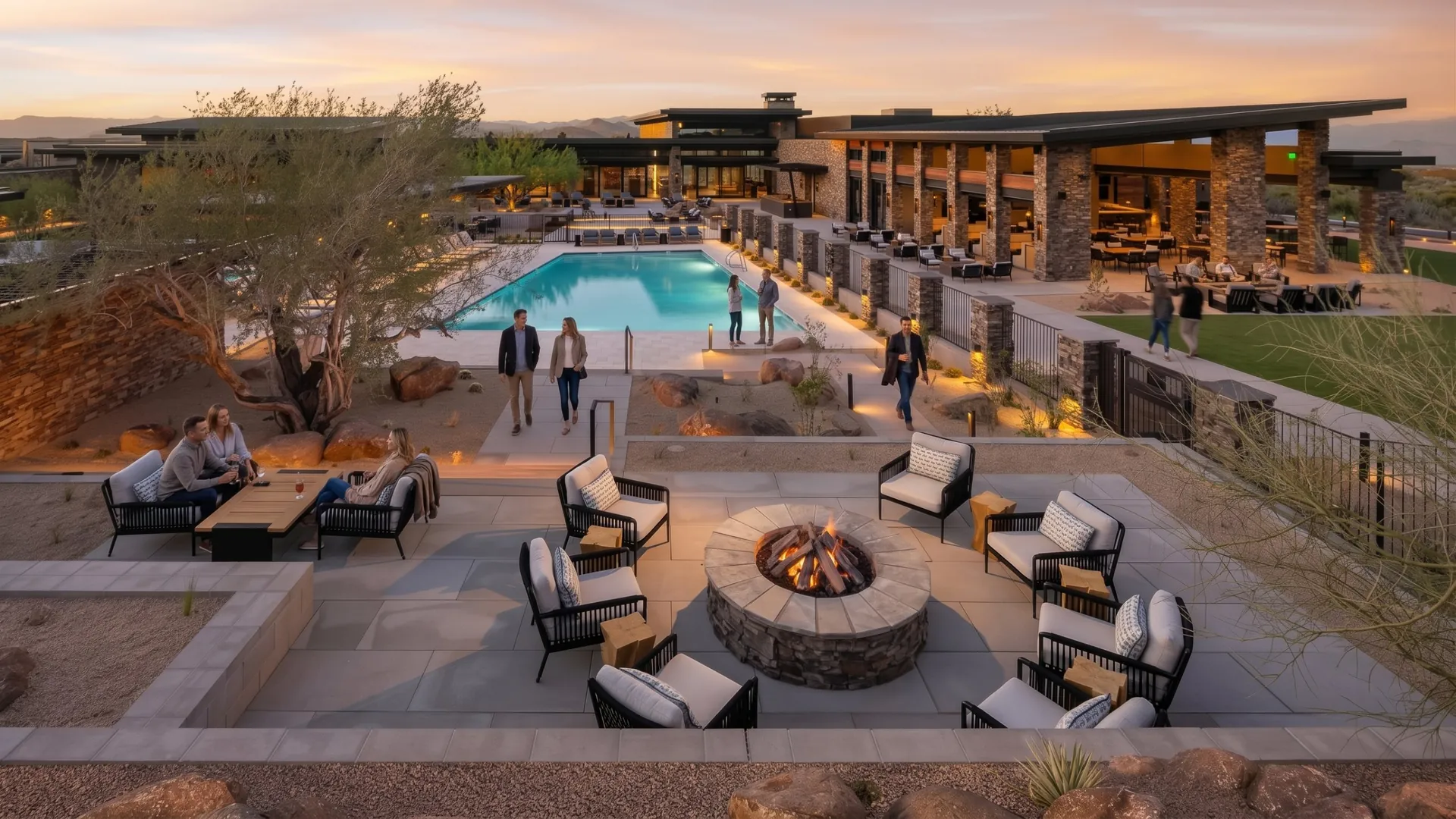 Guests by the fire pit and pool at dusk, with Alterra's terrace behind