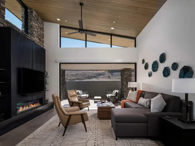 Living area with the glass wall open to the terrace