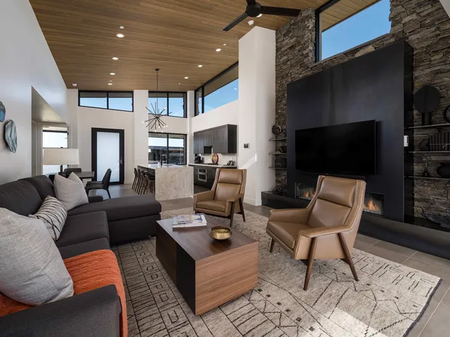 Shale's great room with a black steel fireplace wall and clerestory windows