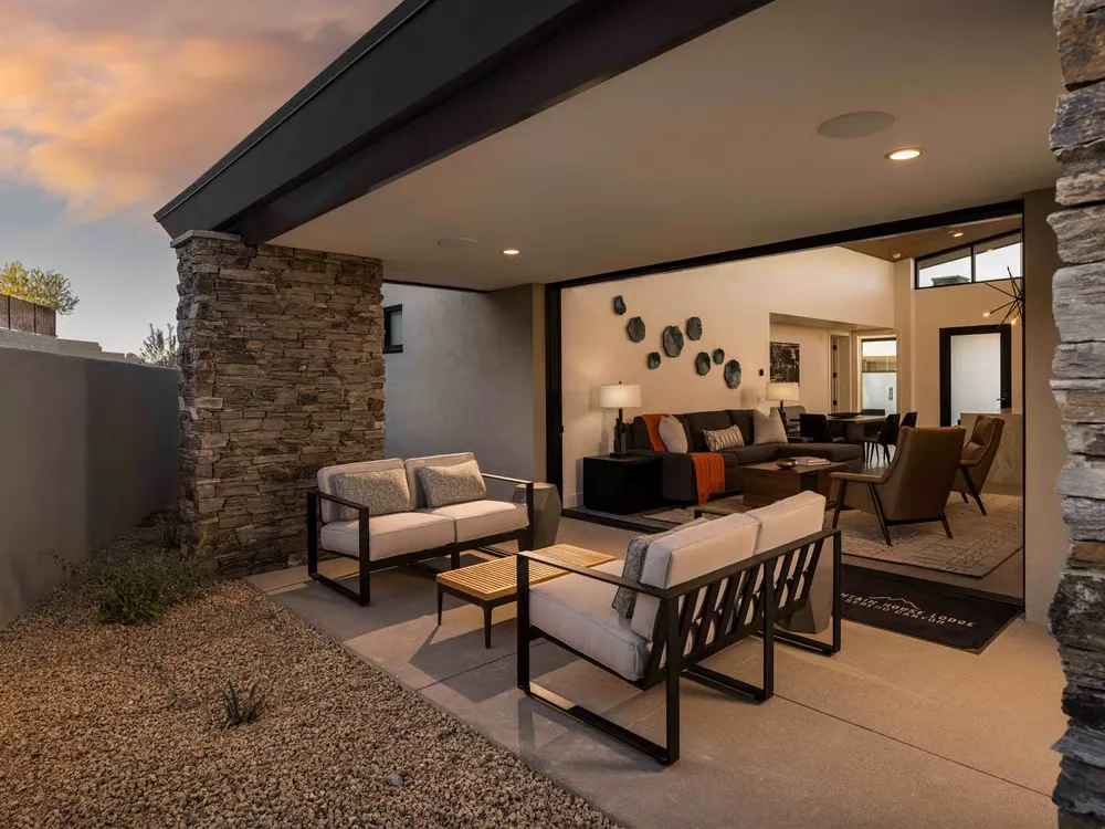 Covered terrace with lounge chairs, open to the great room